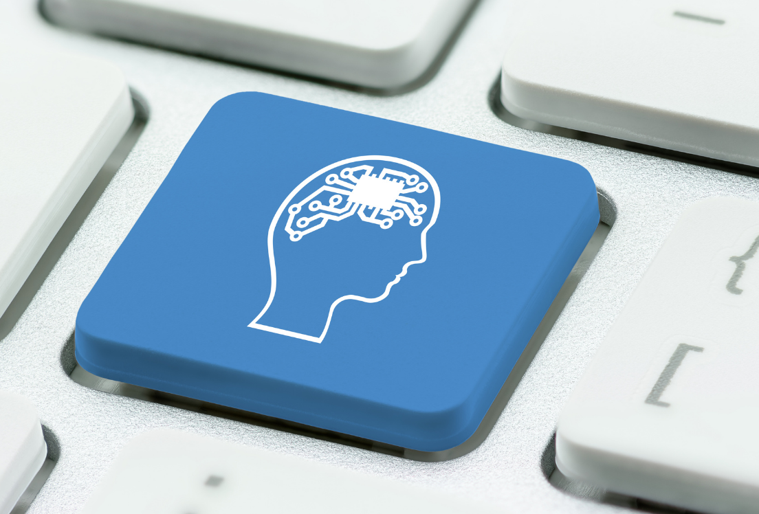 Un teclado de ordenador gris con una tecla azul con un icono de una cabeza